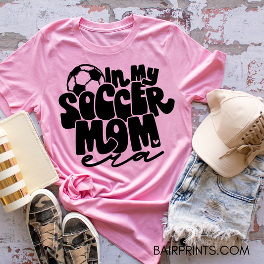 In my soccer mom era t-shirt with a soccer ball.